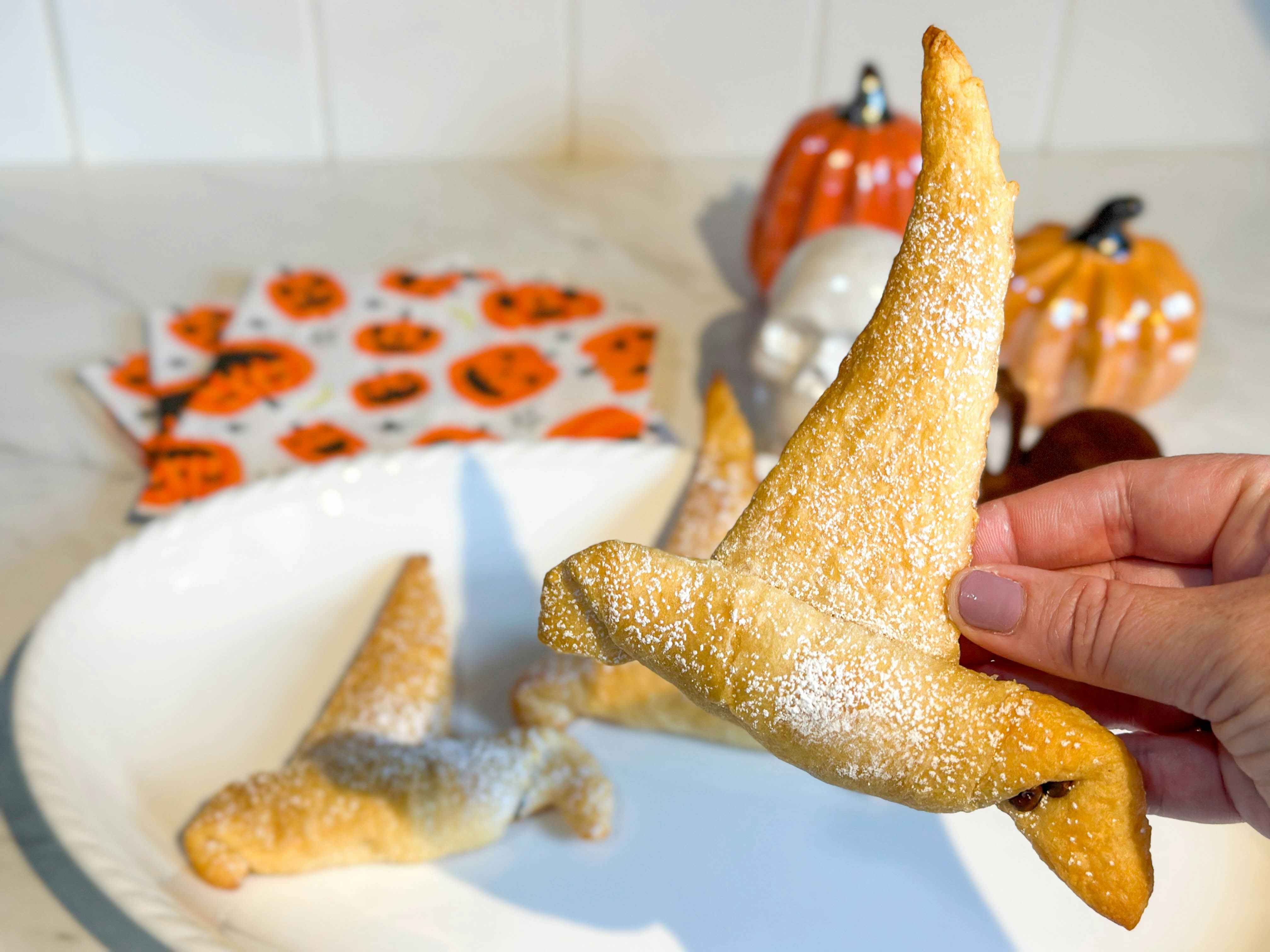 a crescent roll witches hat being held up 