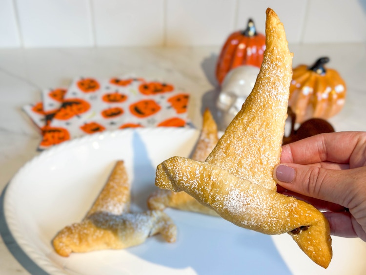 a crescent roll witches hat being held up 