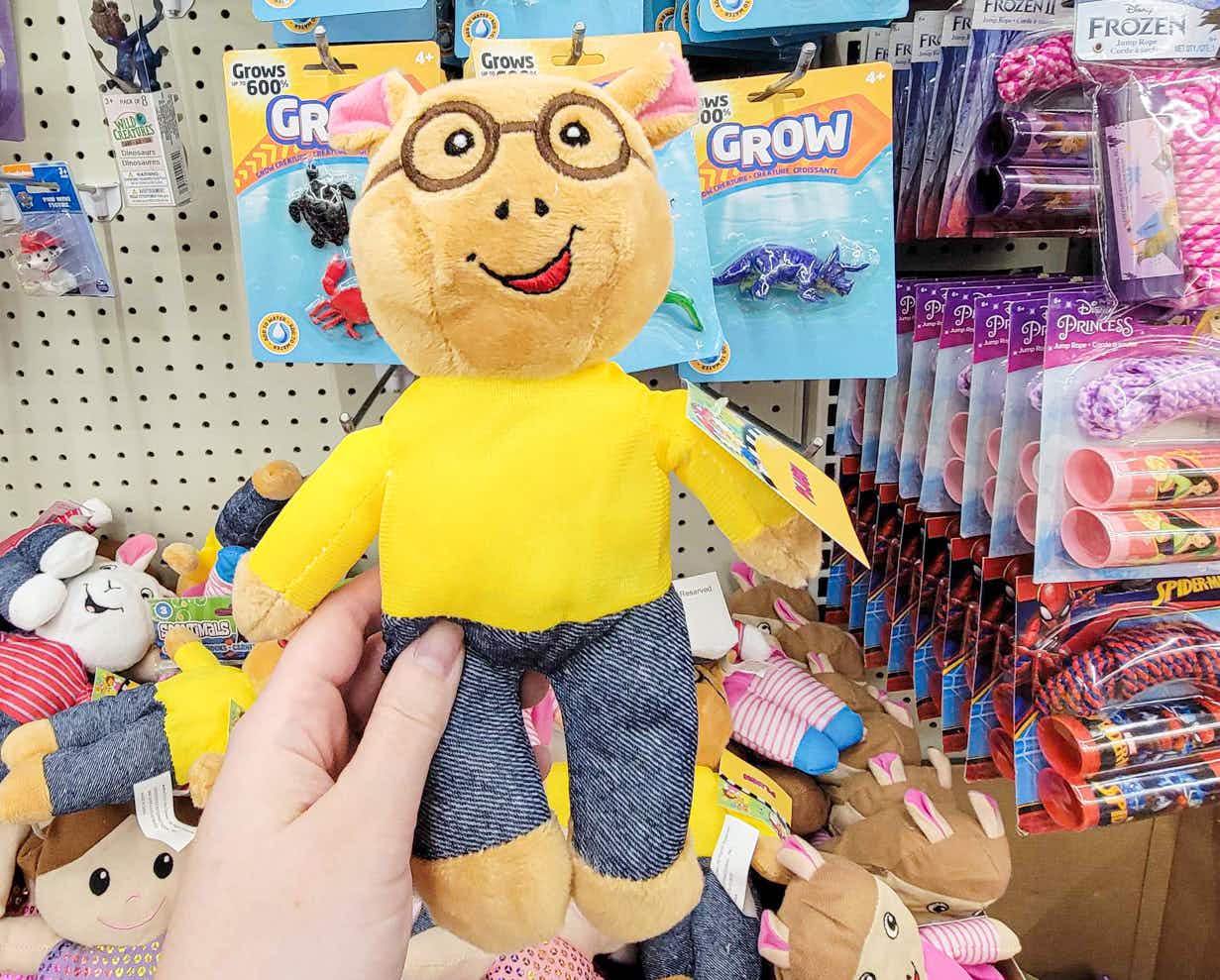 hand holding an arthur plush character toy