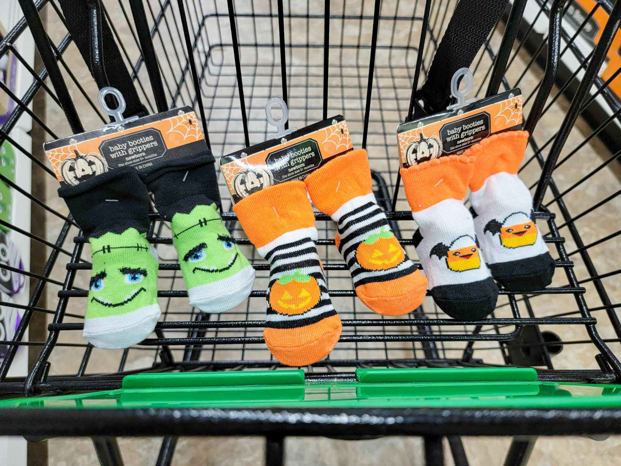3 pairs of halloween baby booties in a cart