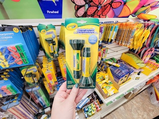 hand holding a pack of crayola glue sticks