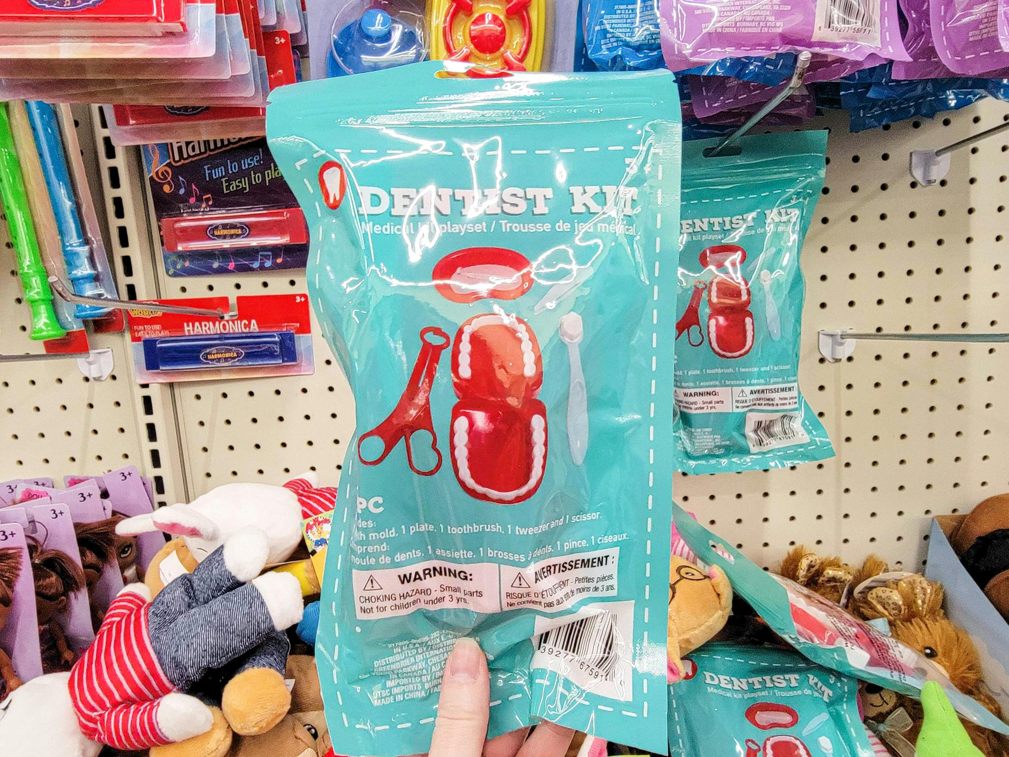 hand holding a dentist playset