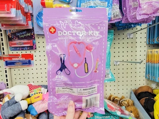 hand holding a doctor playset