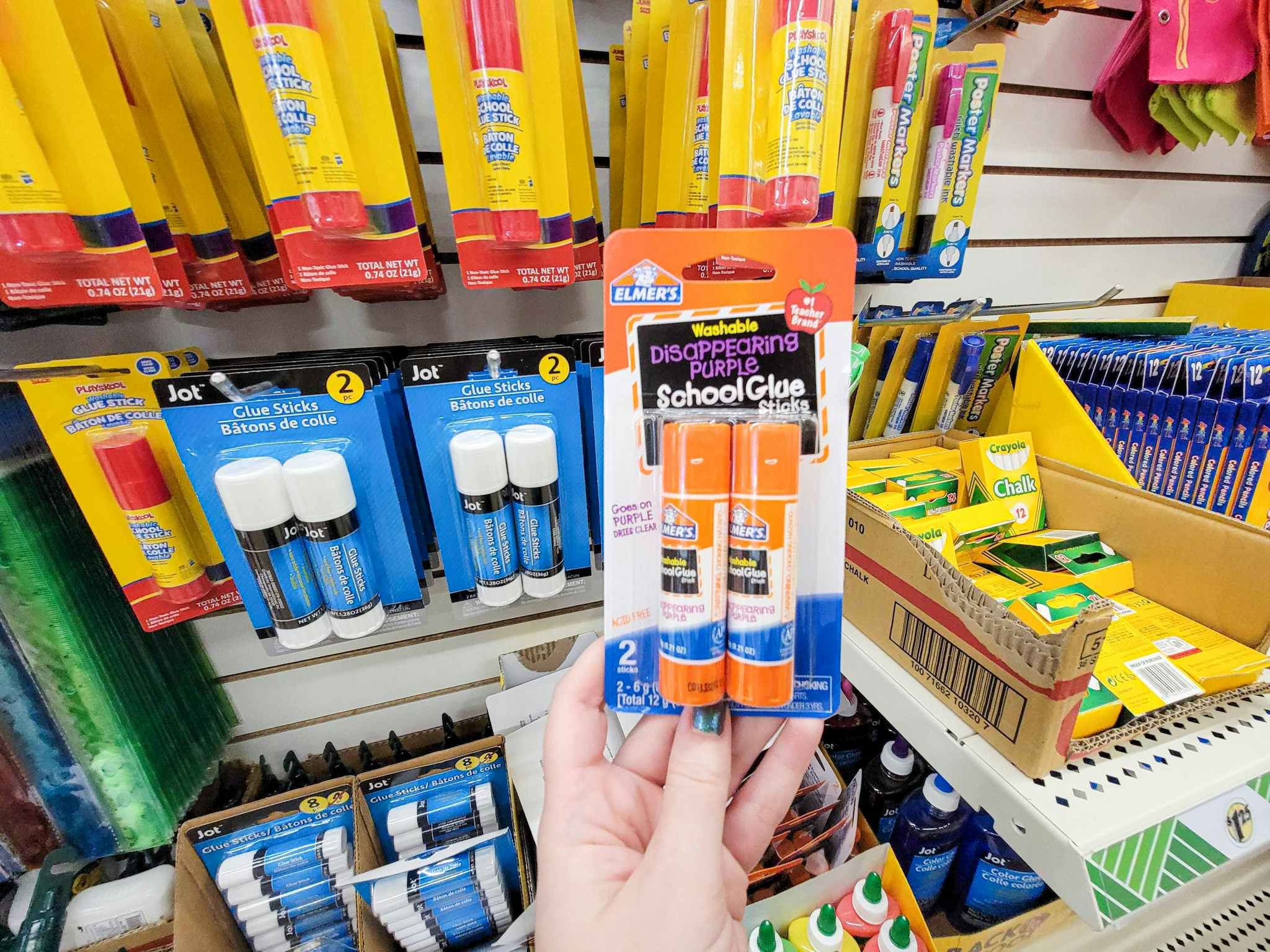 hand holding a 2 pack of elmers glue sticks