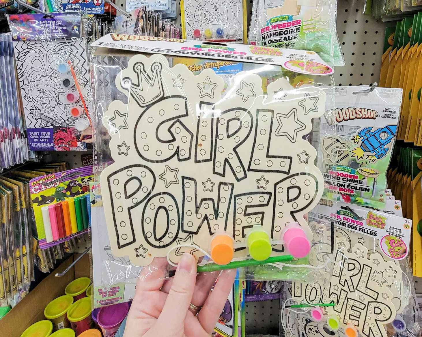 hand holding up a wood painting kit for kids that says girl power
