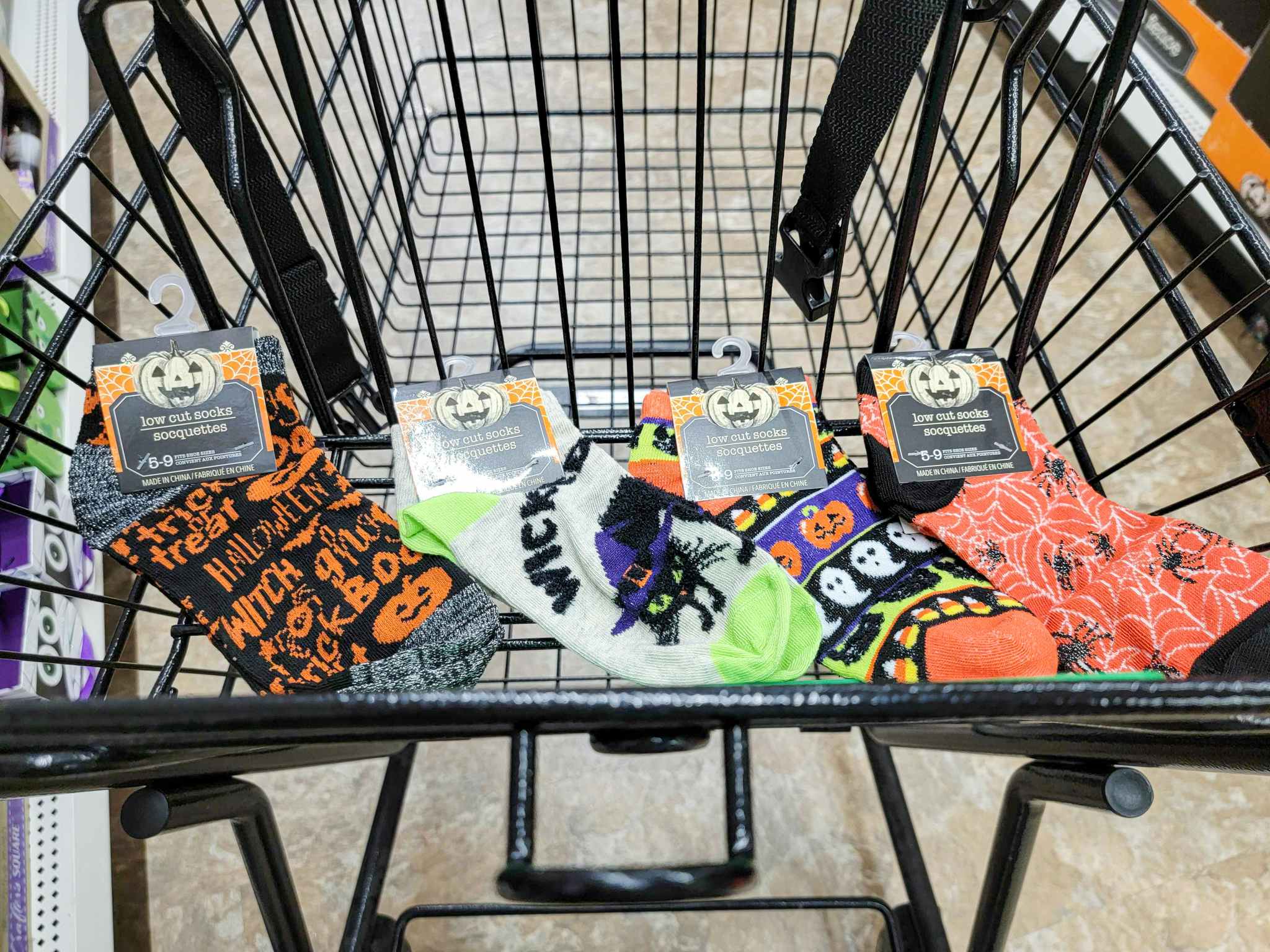 four pairs of halloween socks in a cart