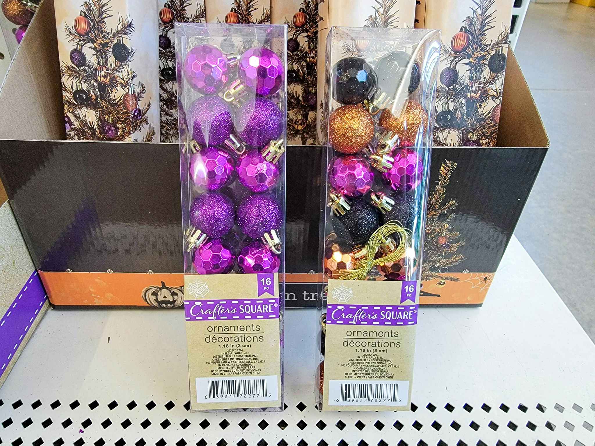 two small packs of purple, orange, and black ornaments for halloween trees