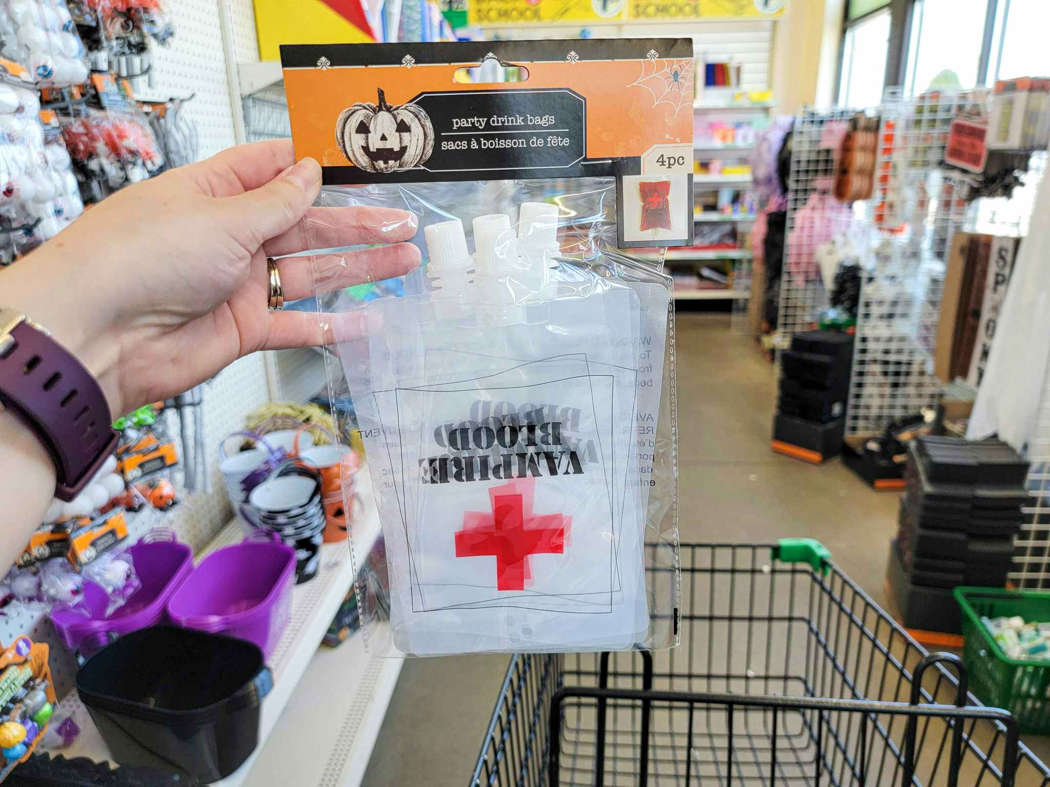 hand holding a pack of clear drink bags that say vampire blood