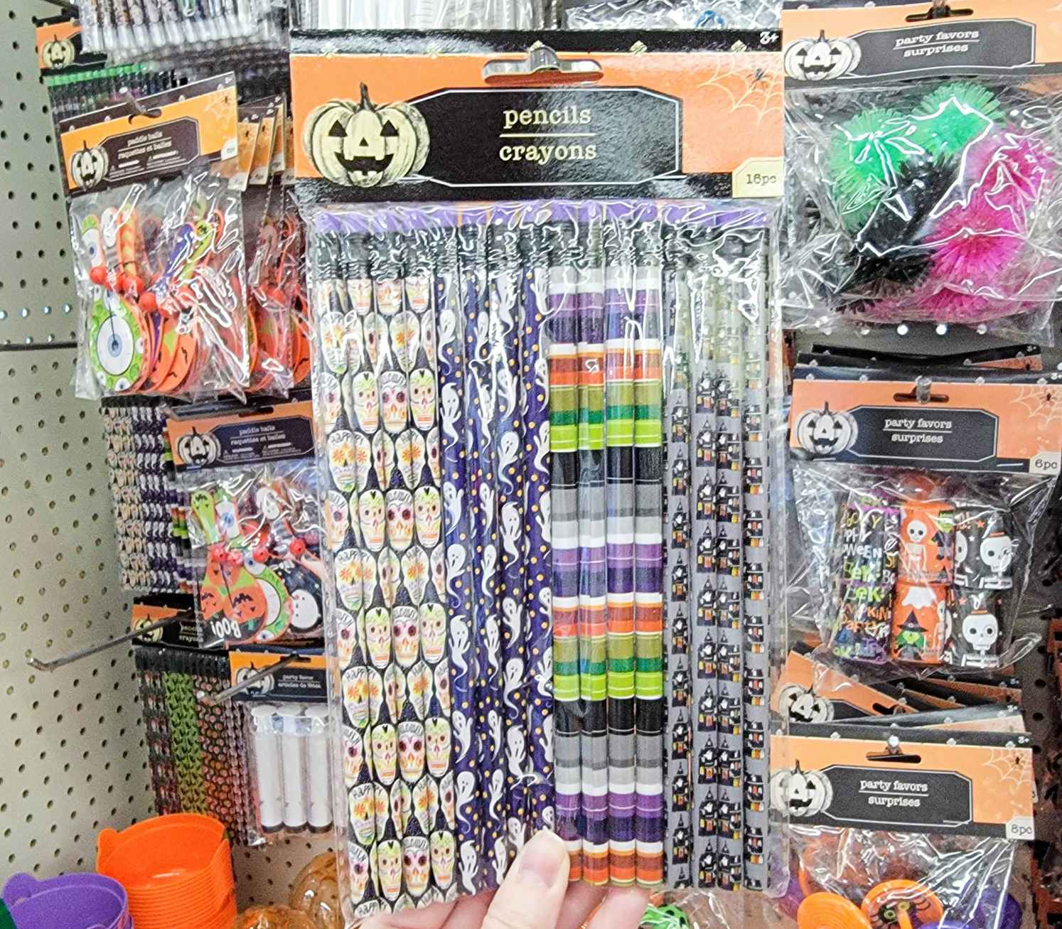 hand holding a pack of halloween pencils