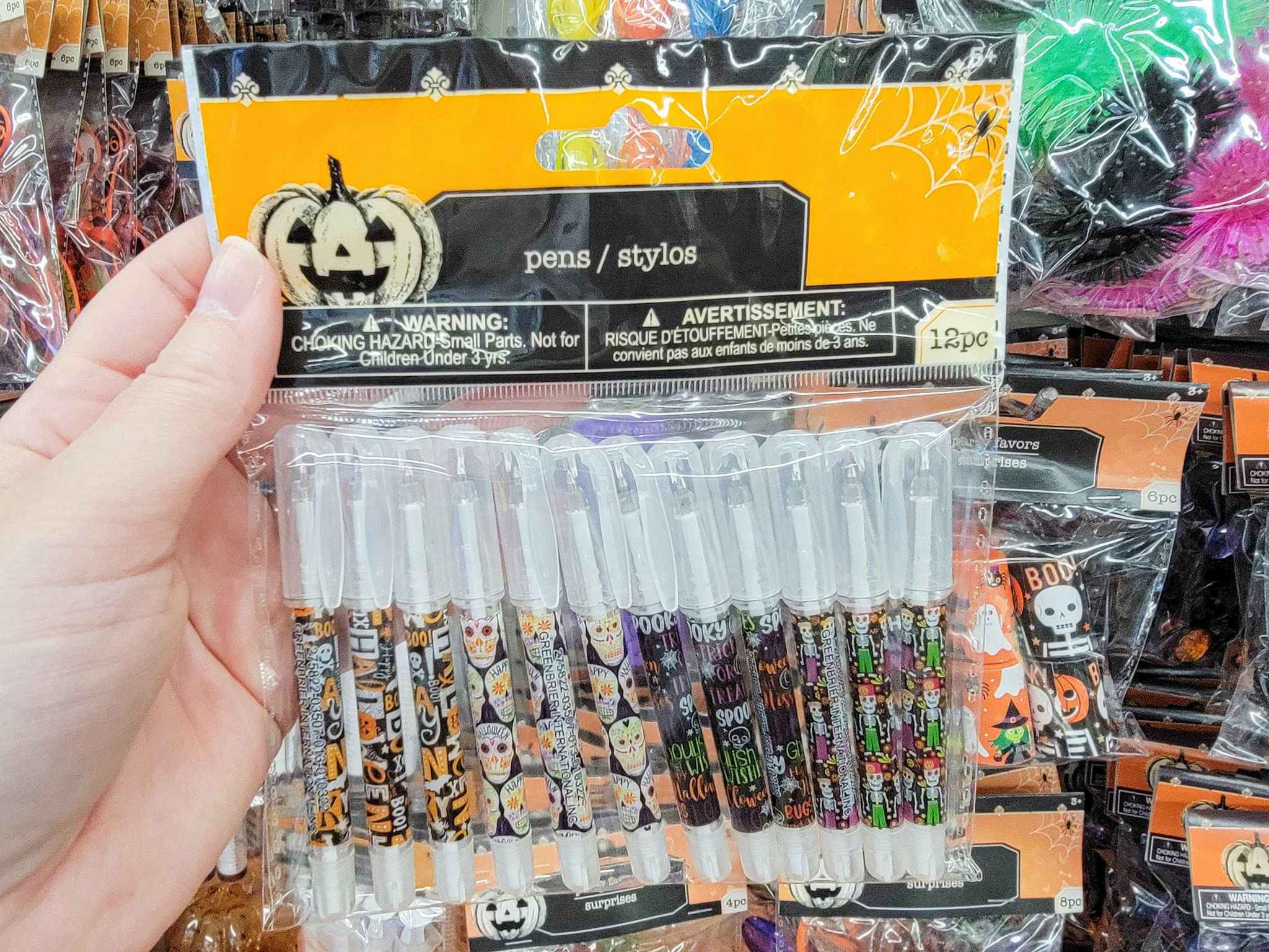 hand holding a pack of halloween pens