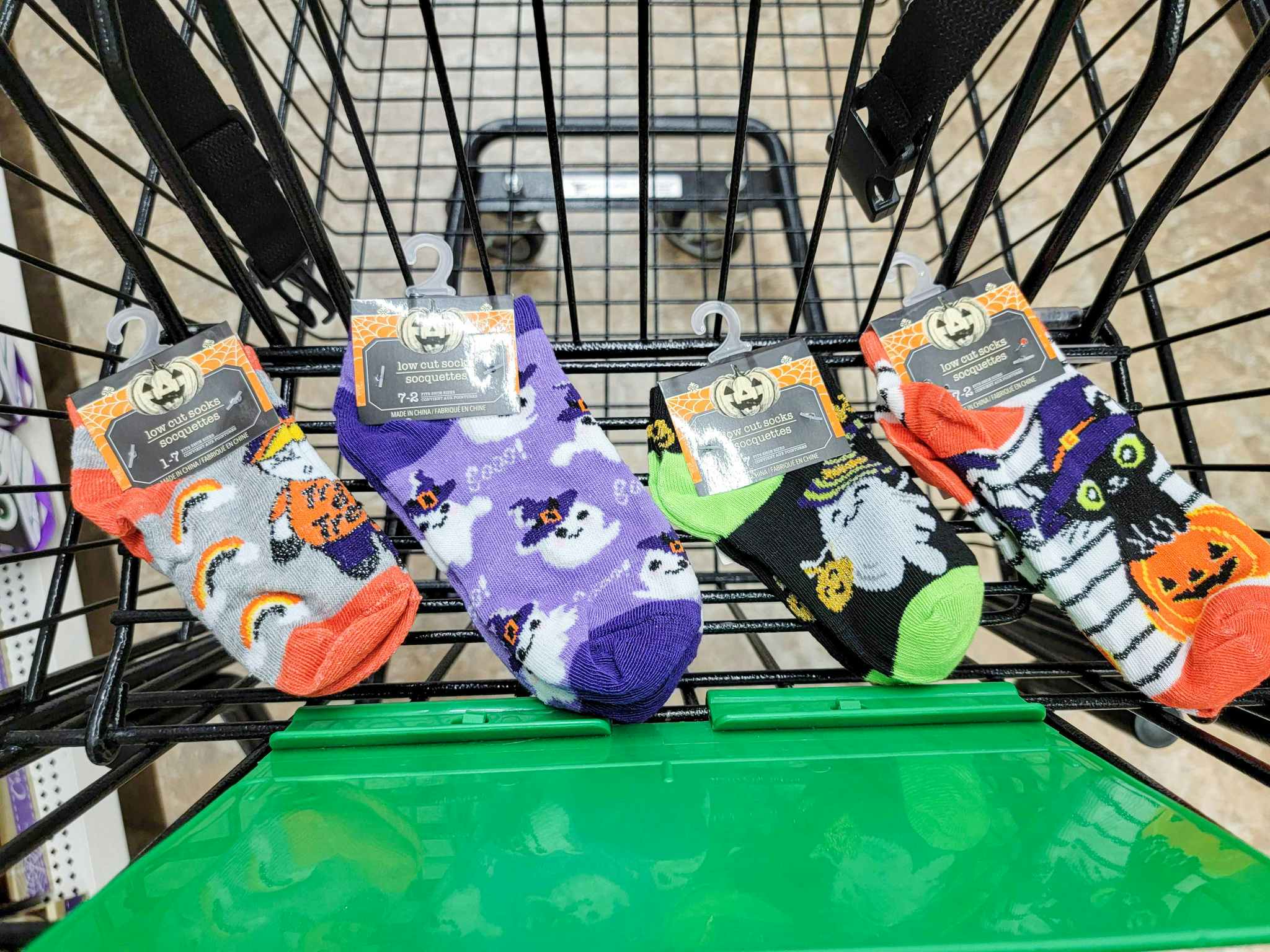 four pairs of kids halloween socks in a cart