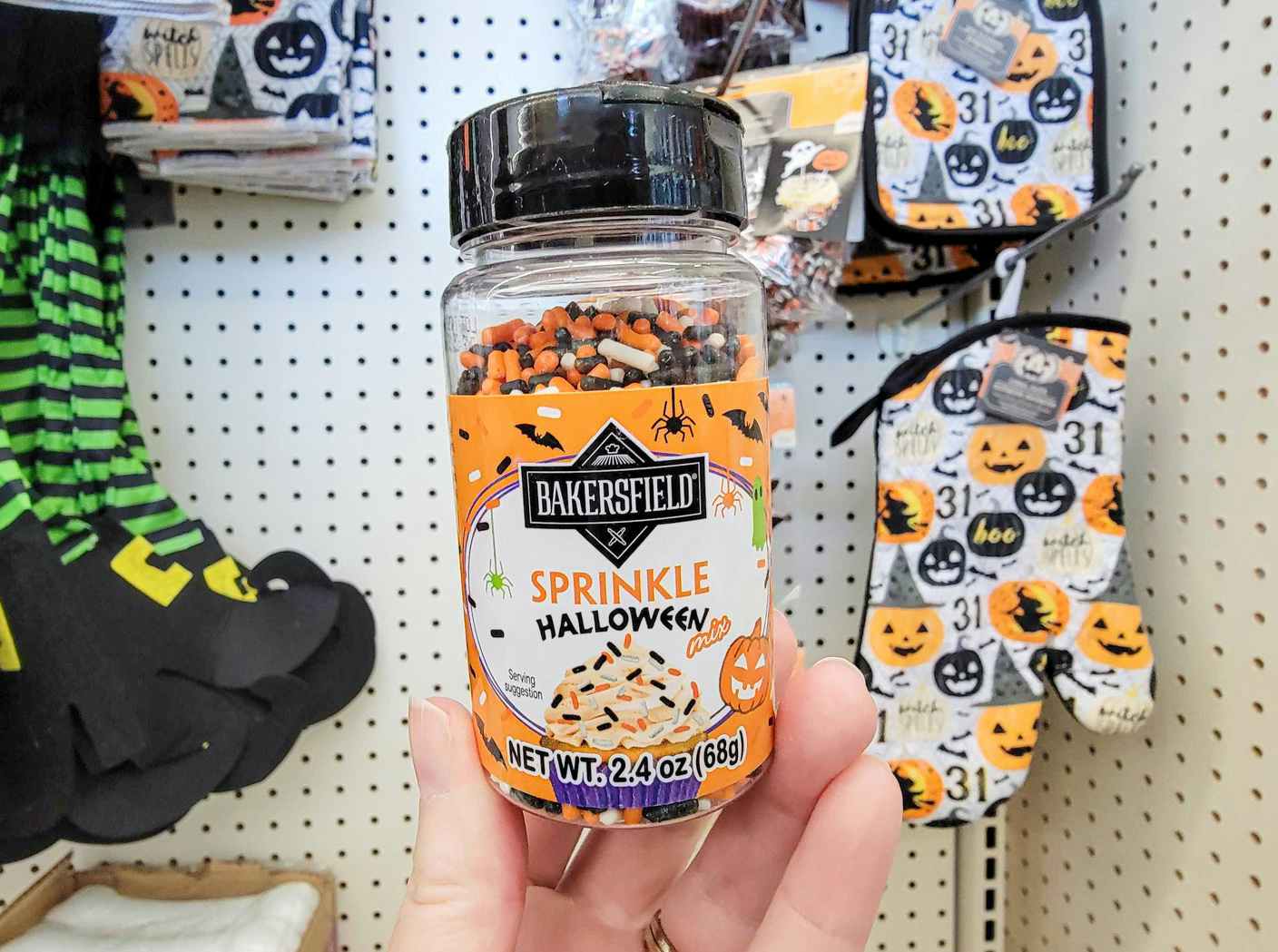 hand holding a pack of halloween sprinkles