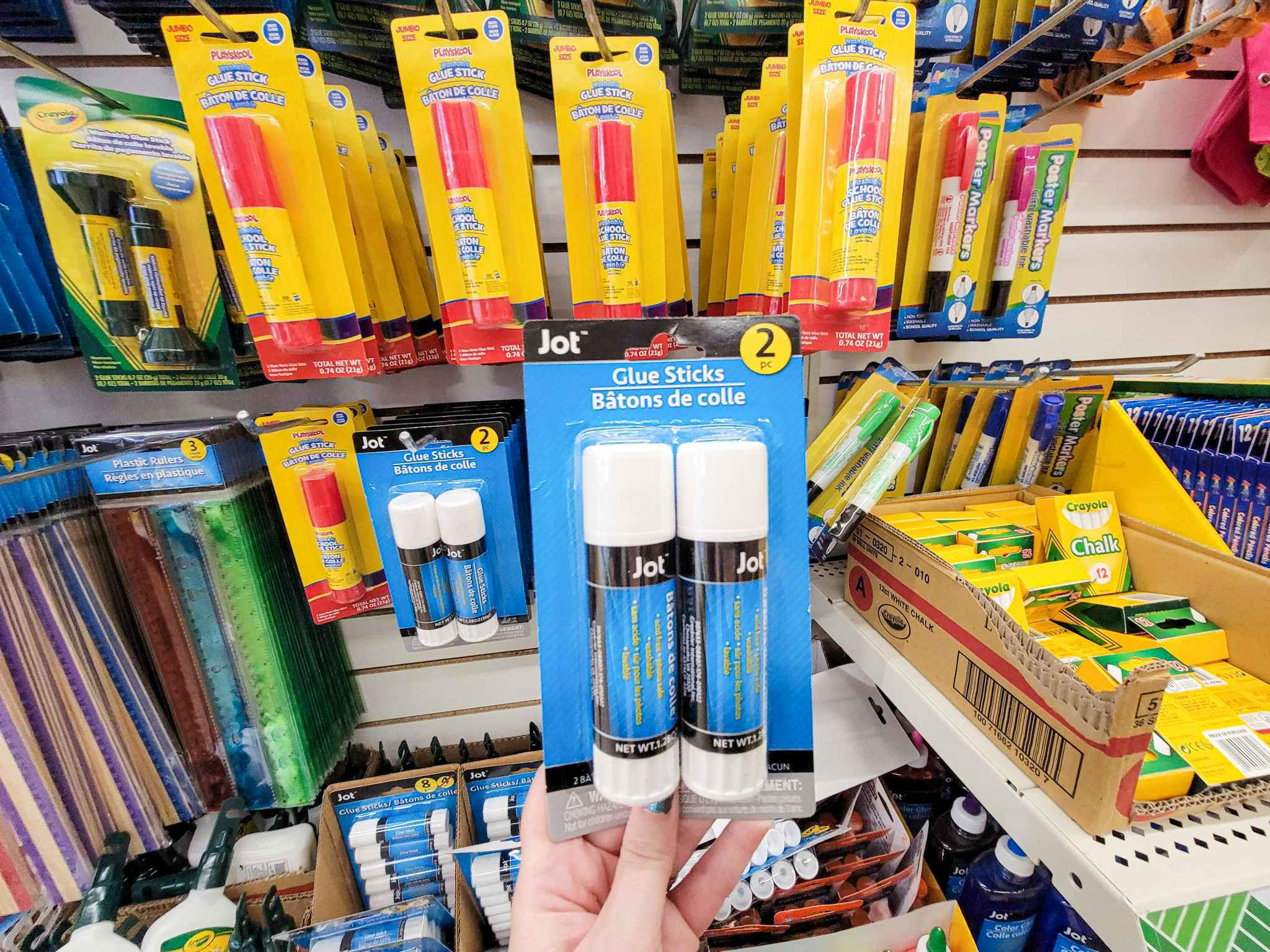 hand holding a 2 pack of large jot brand glue sticks