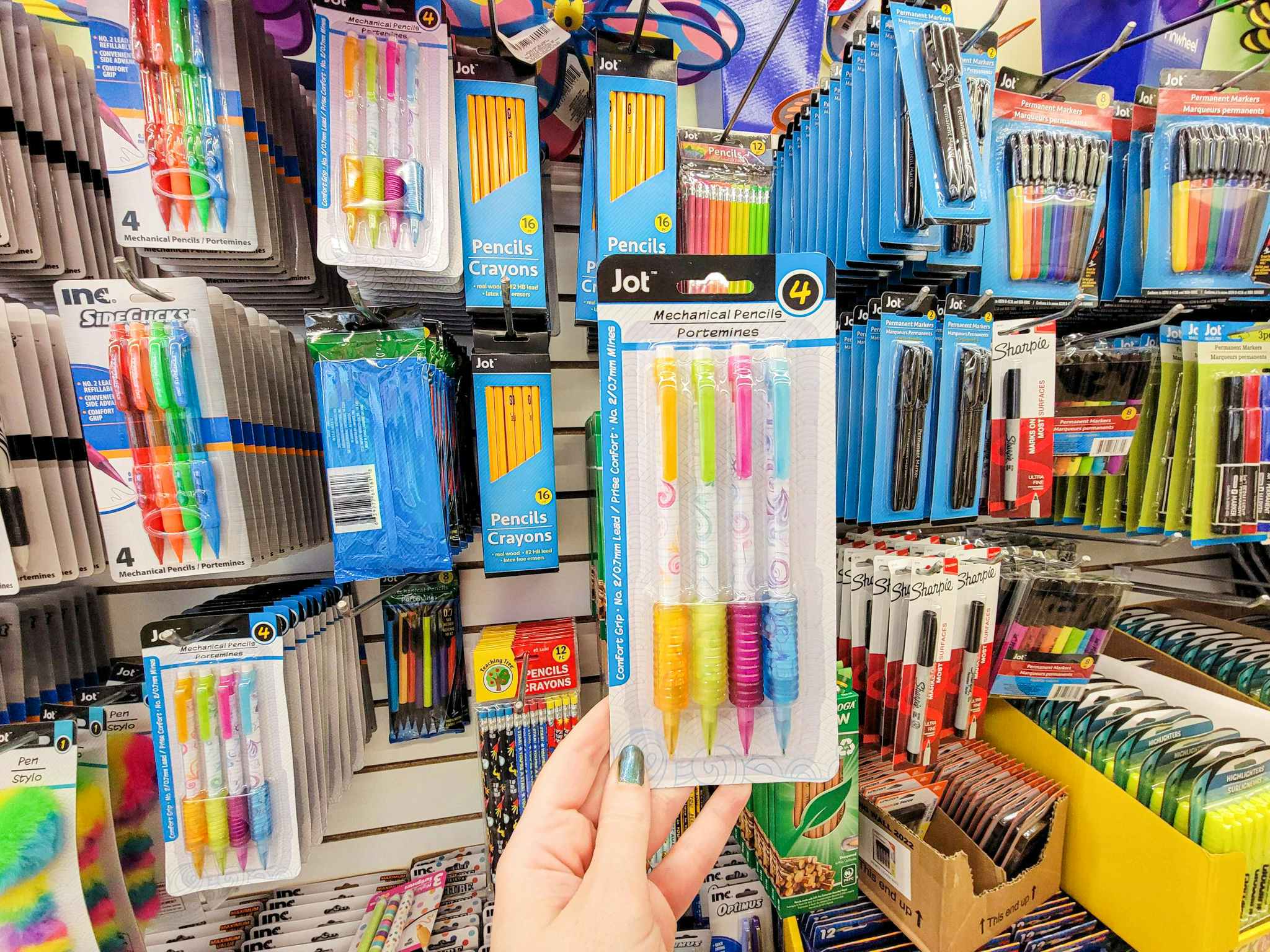 hand holding a package of mechanical pencils