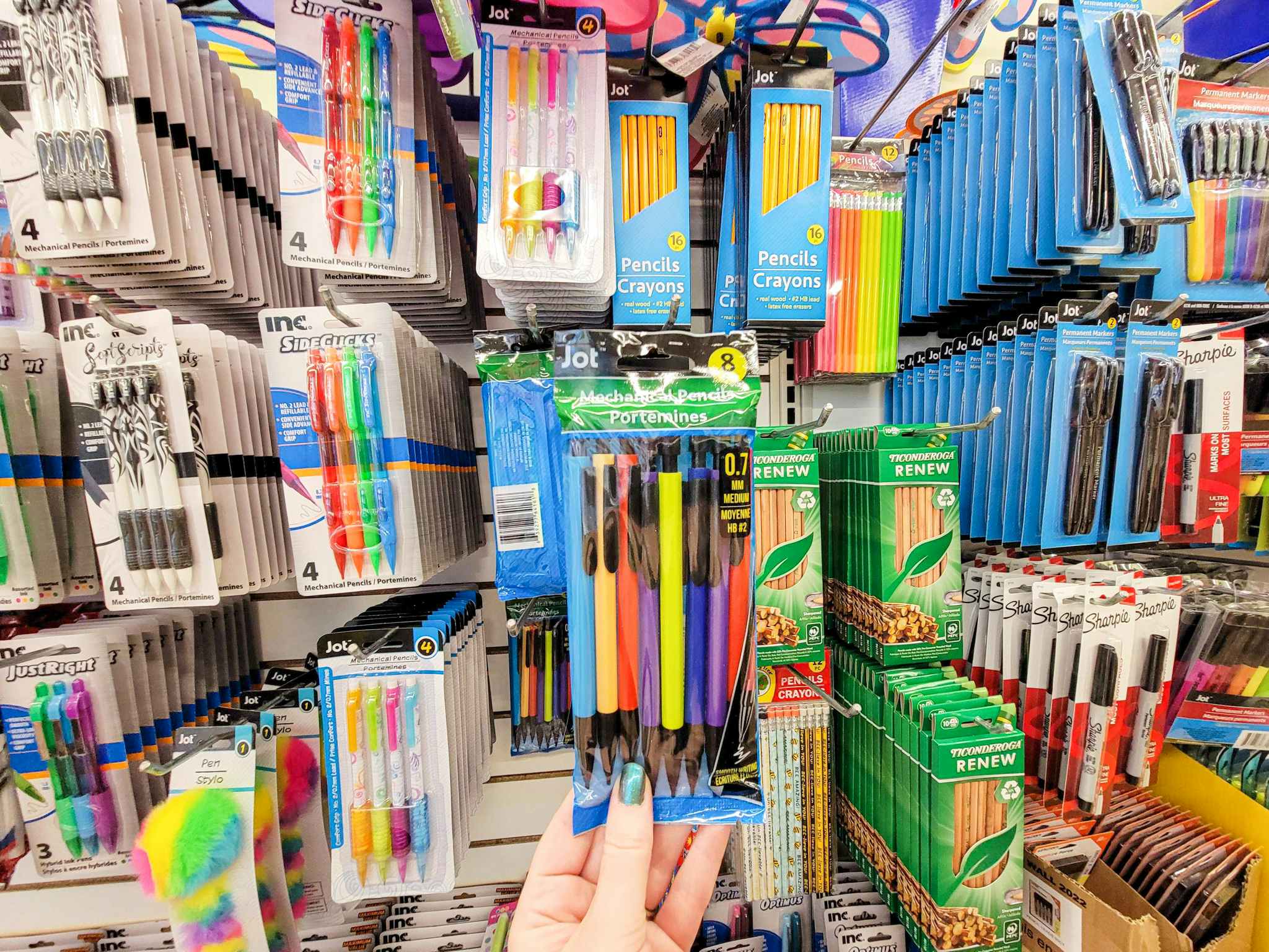 hand holding a pack of mechanical pencils