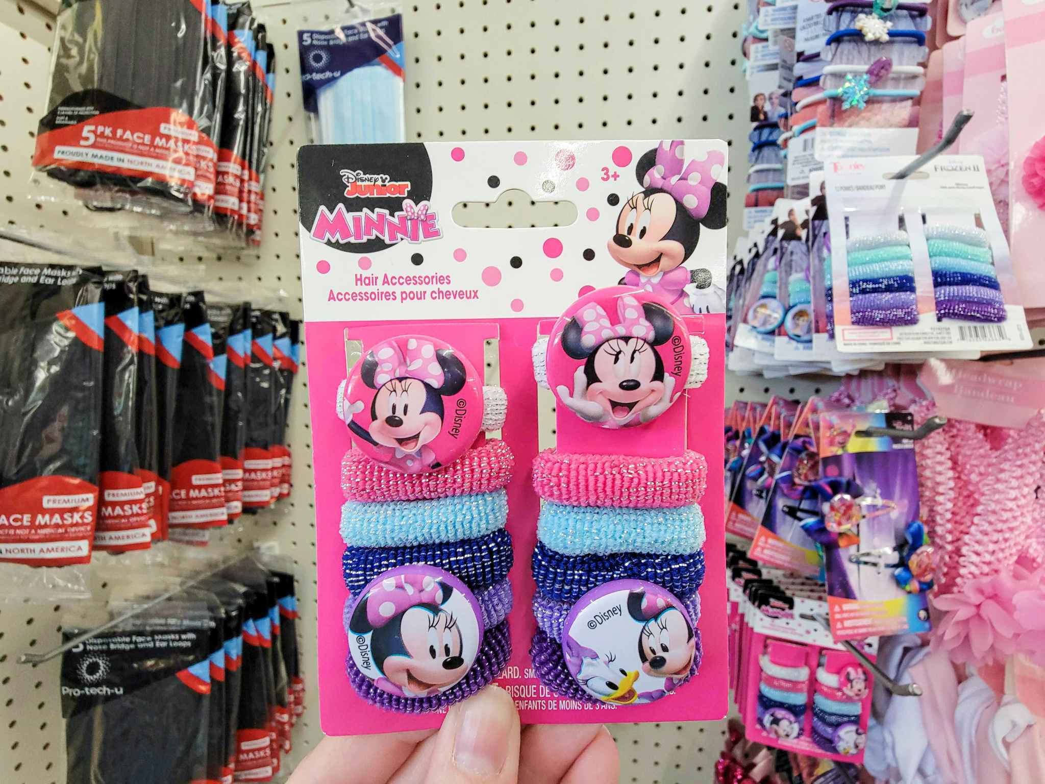 hand holding a pack of thick minnie mouse hair ties featuring decals with minnie on them