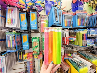 hand holding a pack of neon pencils