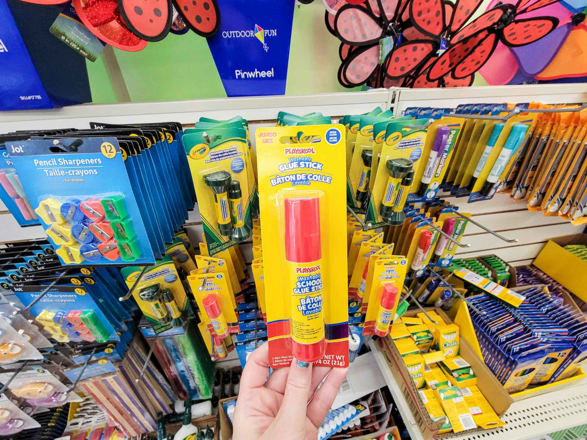 hand holding a playskool glue stick