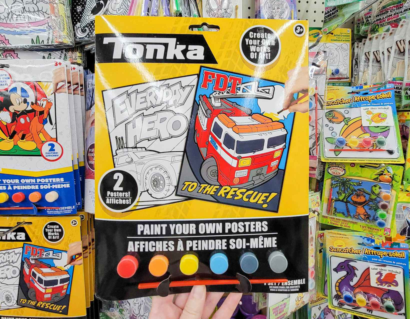 hand holding a pack of tonka painting posters