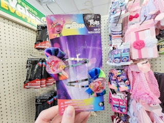 hand holding a 2 pack of trolls hair clips