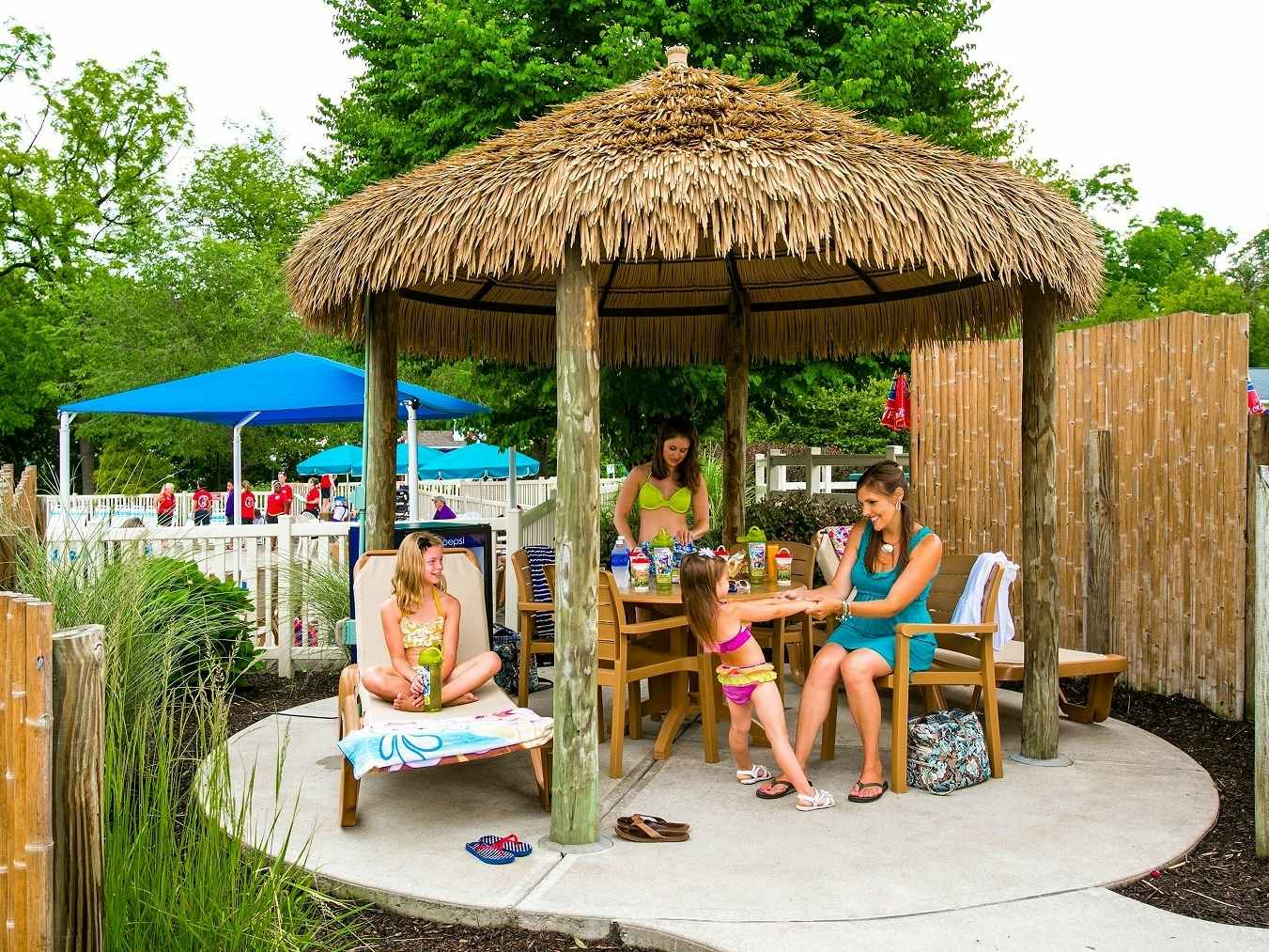A family relaxing at a cabana near the water park in Dutch Wonderland.