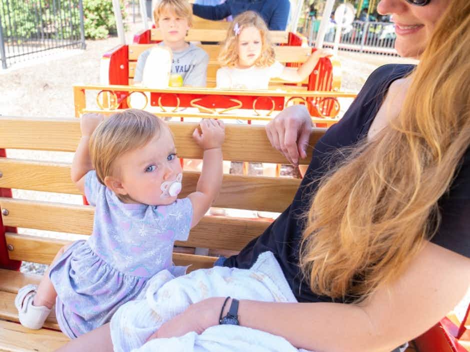 A mom and her children riding a train at the Dutch Wonderland park.
