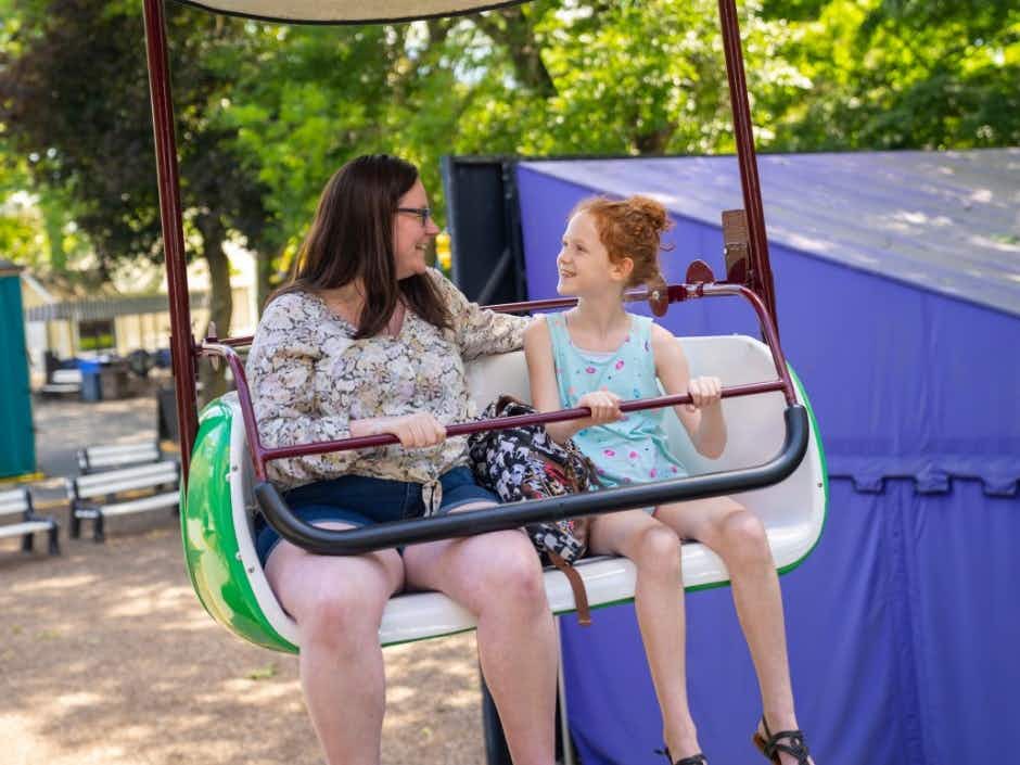 A mom and daughter riding a ride together at Dutch Wonderland