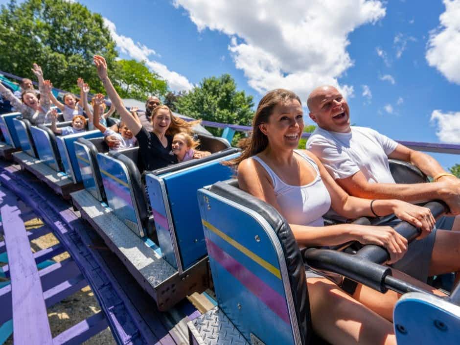 A group of people riding a rollercoaster at Dutch Wonderland.