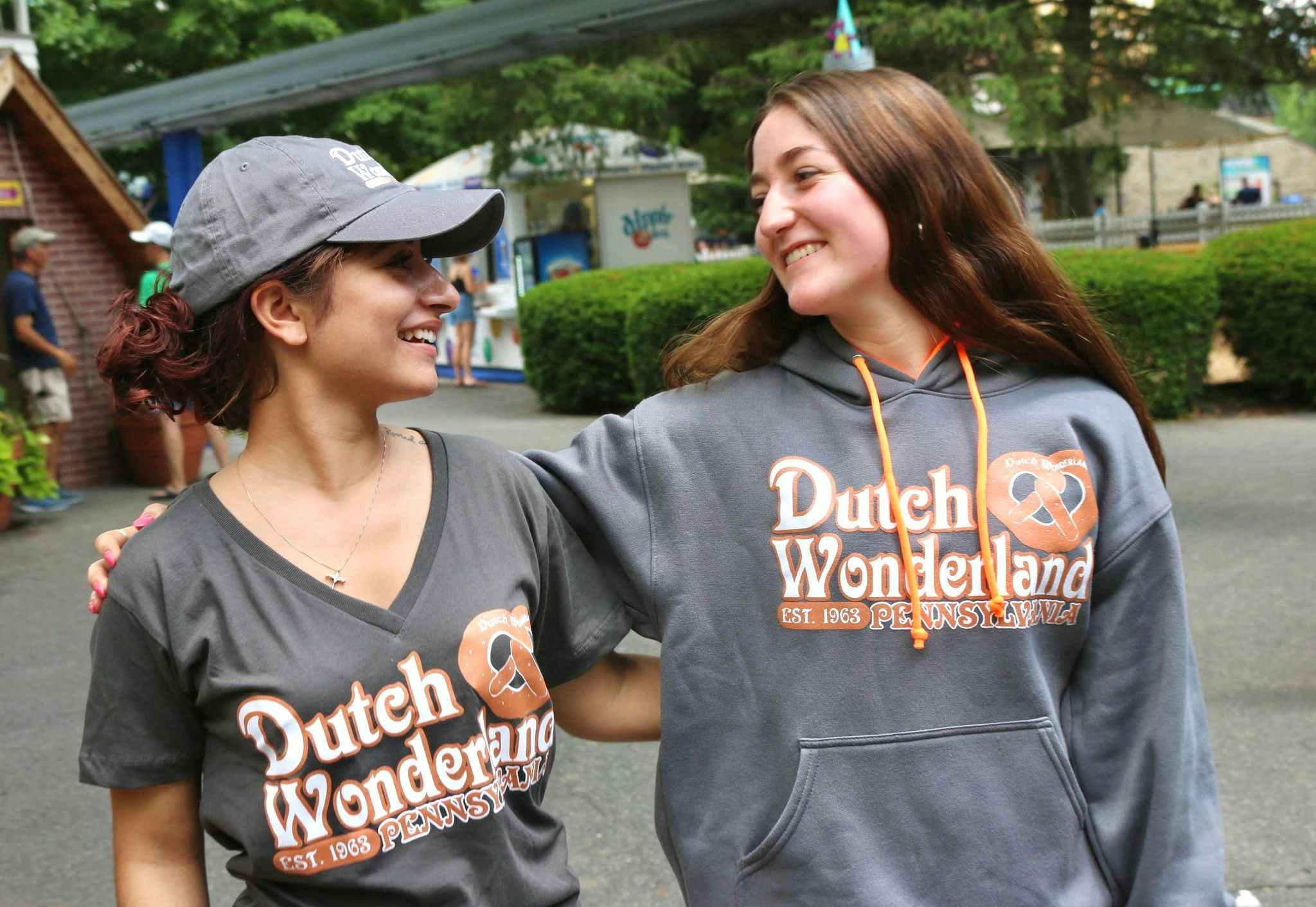 Two friends wearing Dutch Wonderland merchandise having fun at the park.