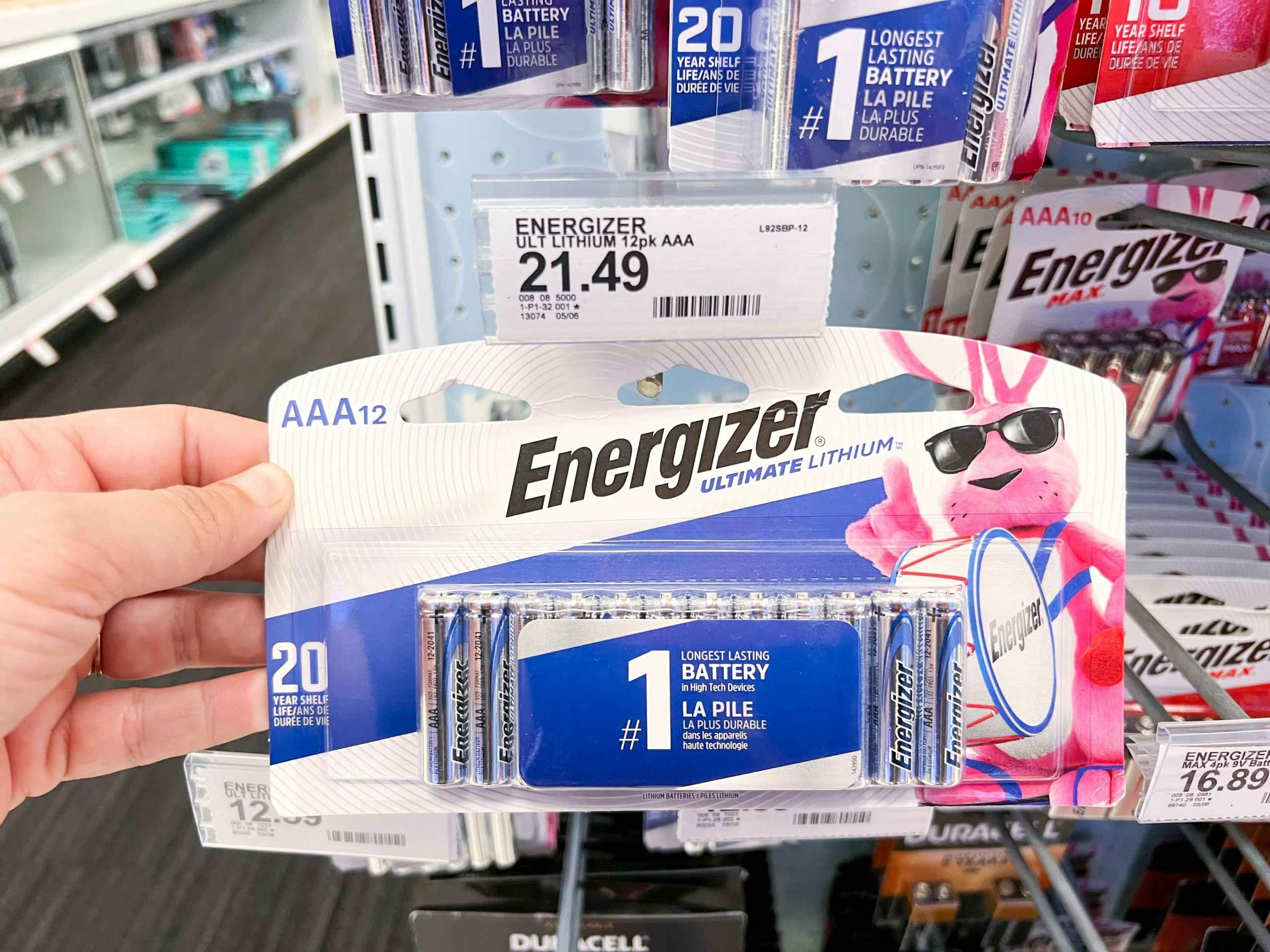 hand holding up a package of Energizer batteries at Target in front of price sign