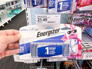hand holding up a package of Energizer batteries at Target in front of price sign