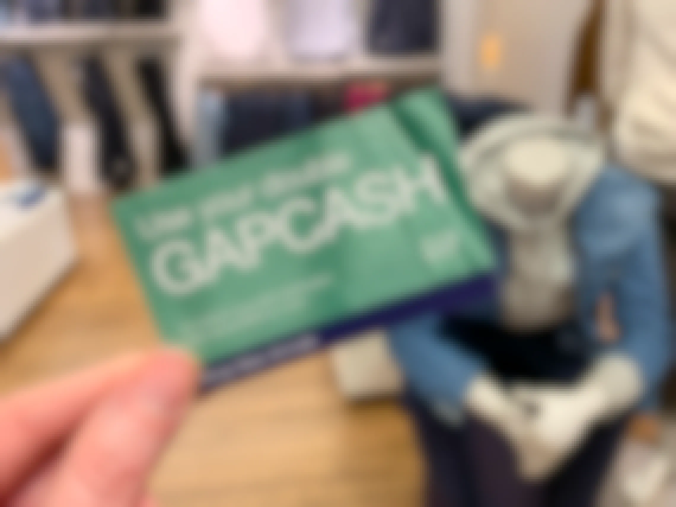 A person holding Gap cash in a gap store.