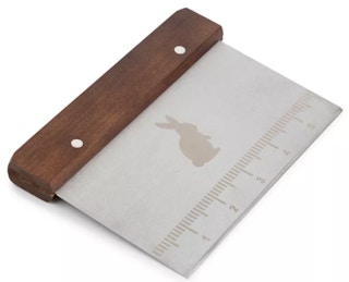 a bench scrapper with a bunny on it