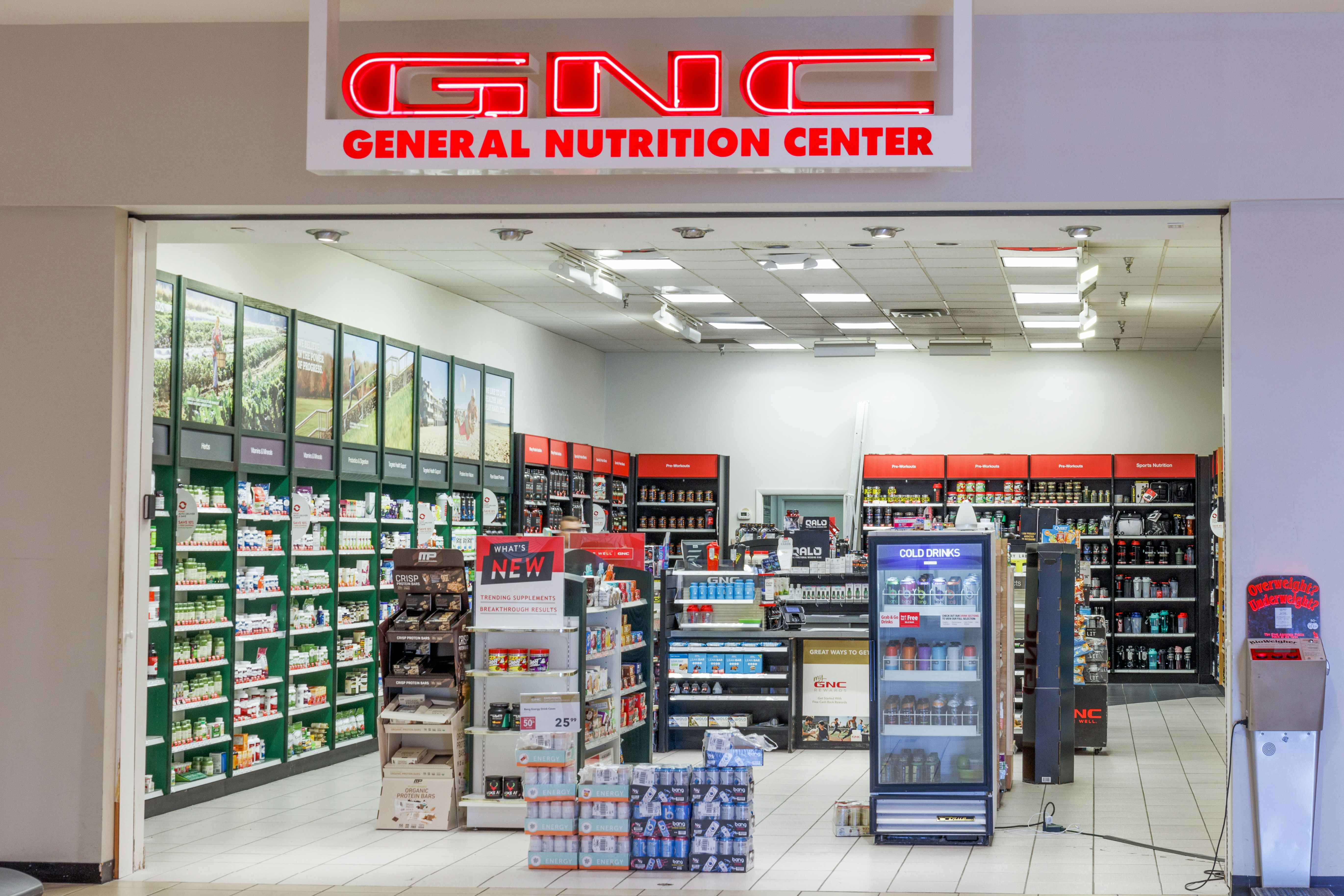 The front entrance of a GNC store inside a mall.