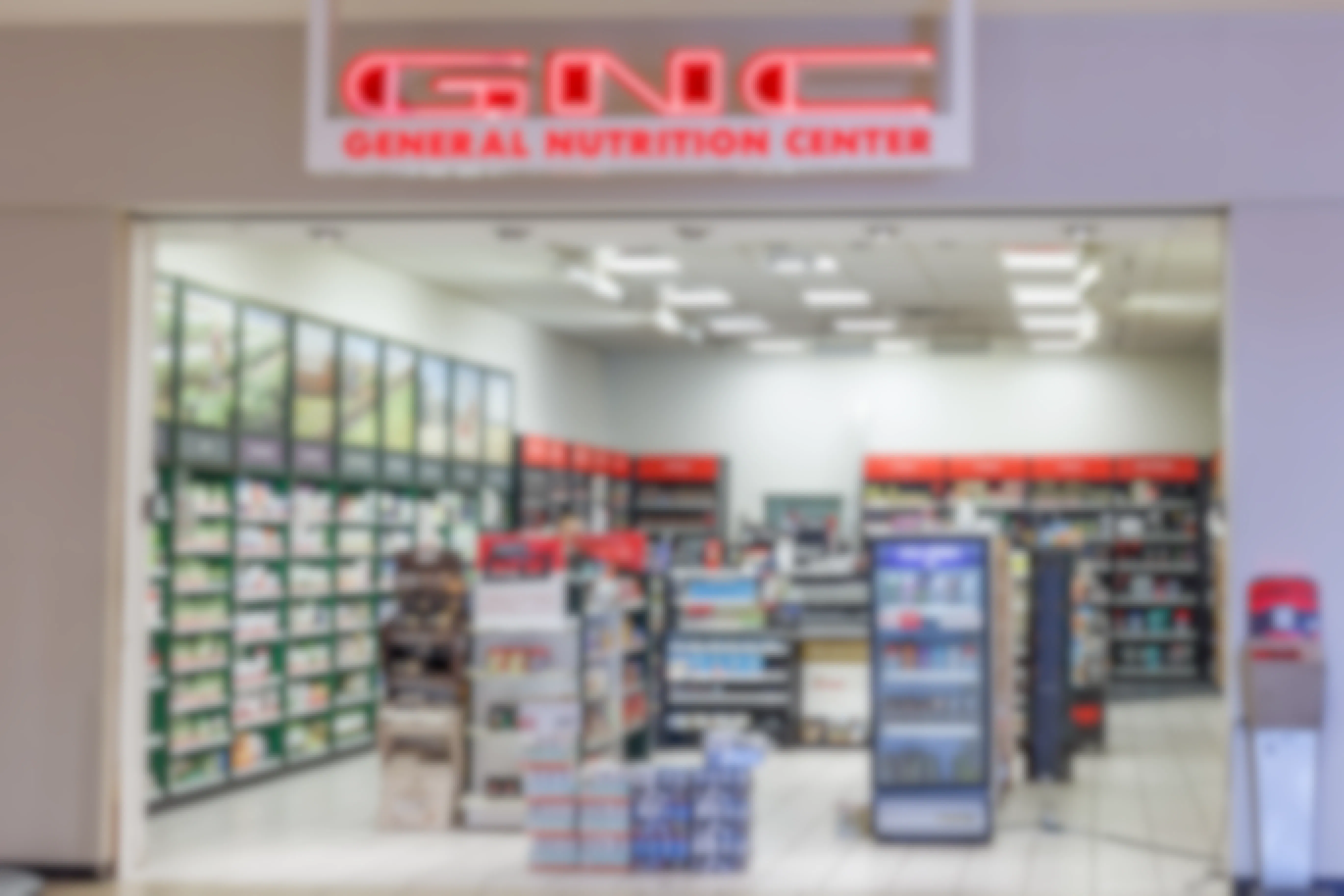 The front entrance of a GNC store inside a mall.