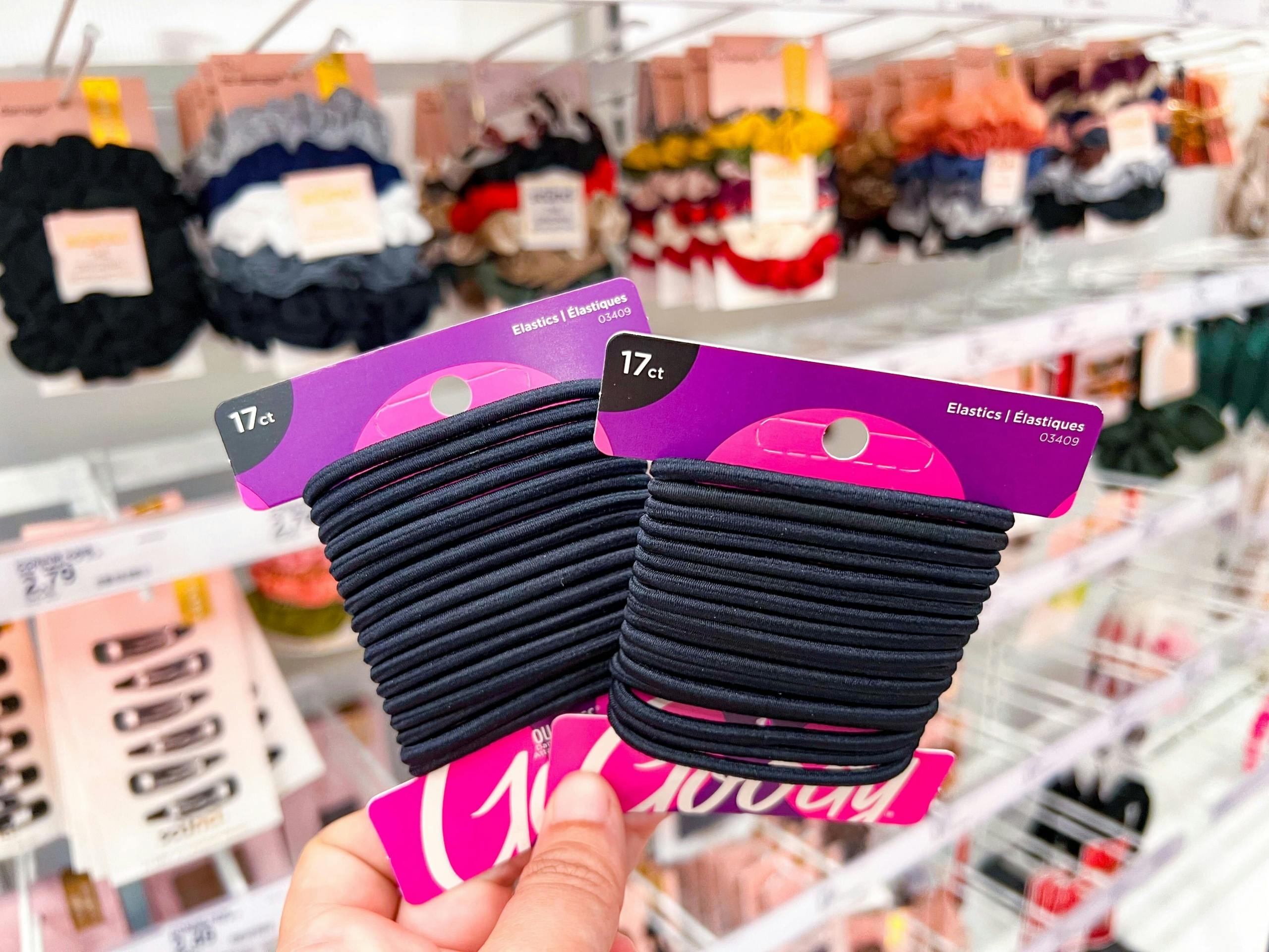 holding up two packs of Goody hair ties at Target