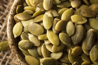 green pepitas pumpkin seeds in bowl