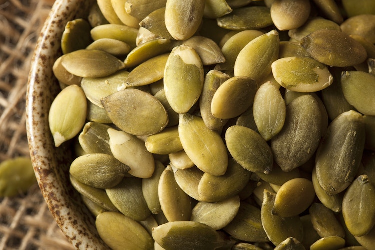 green pepitas pumpkin seeds in bowl