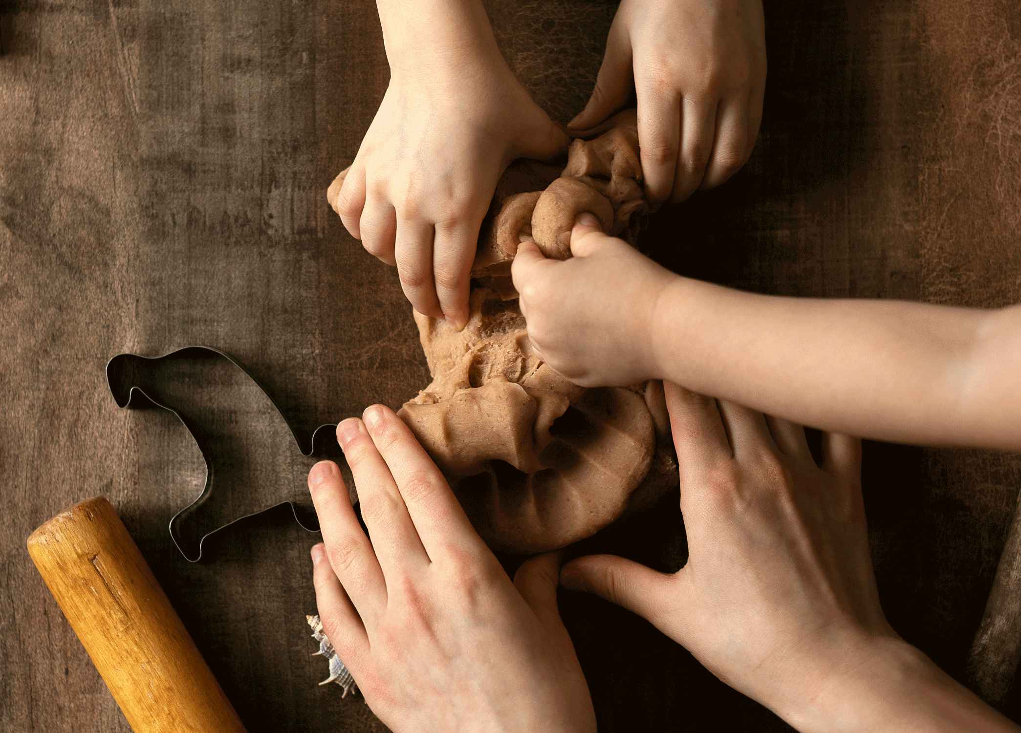 children's hands playing with homemade play dough on table