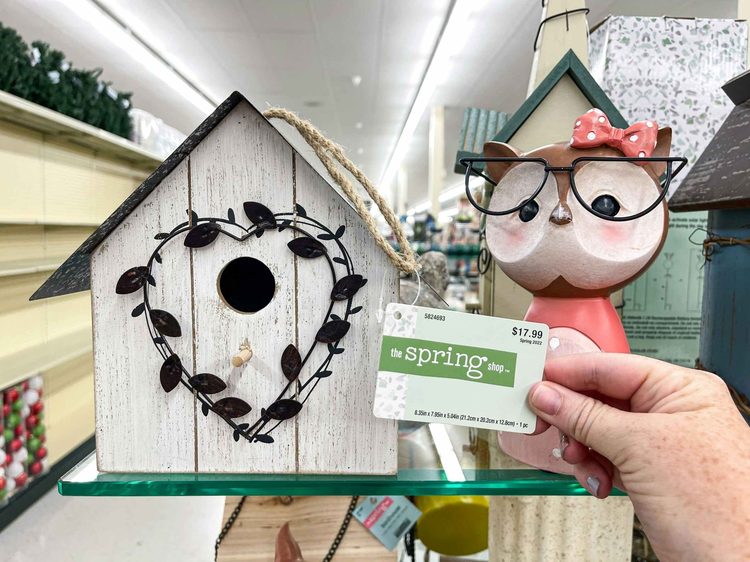 white birdhouse on shelf