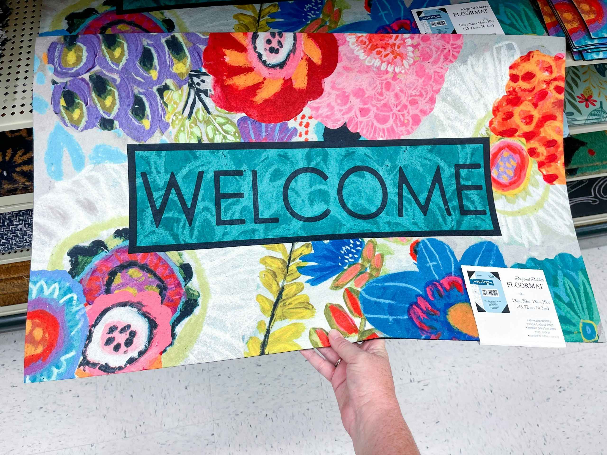 spring doormat with "welcome" and colorful flowers