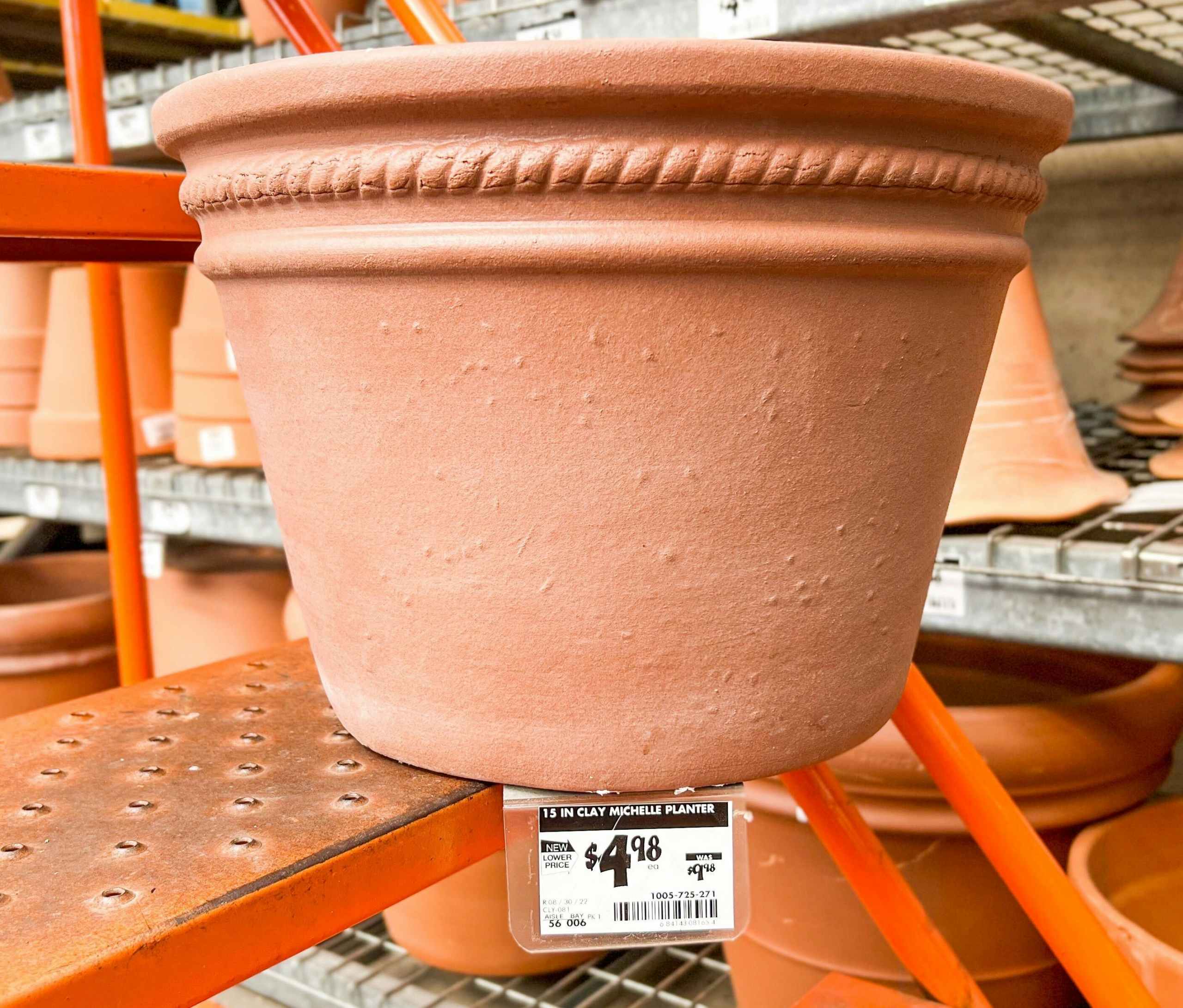 terra cotta planter on stairs with sale price tag