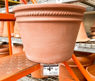 terra cotta planter on stairs with sale price tag
