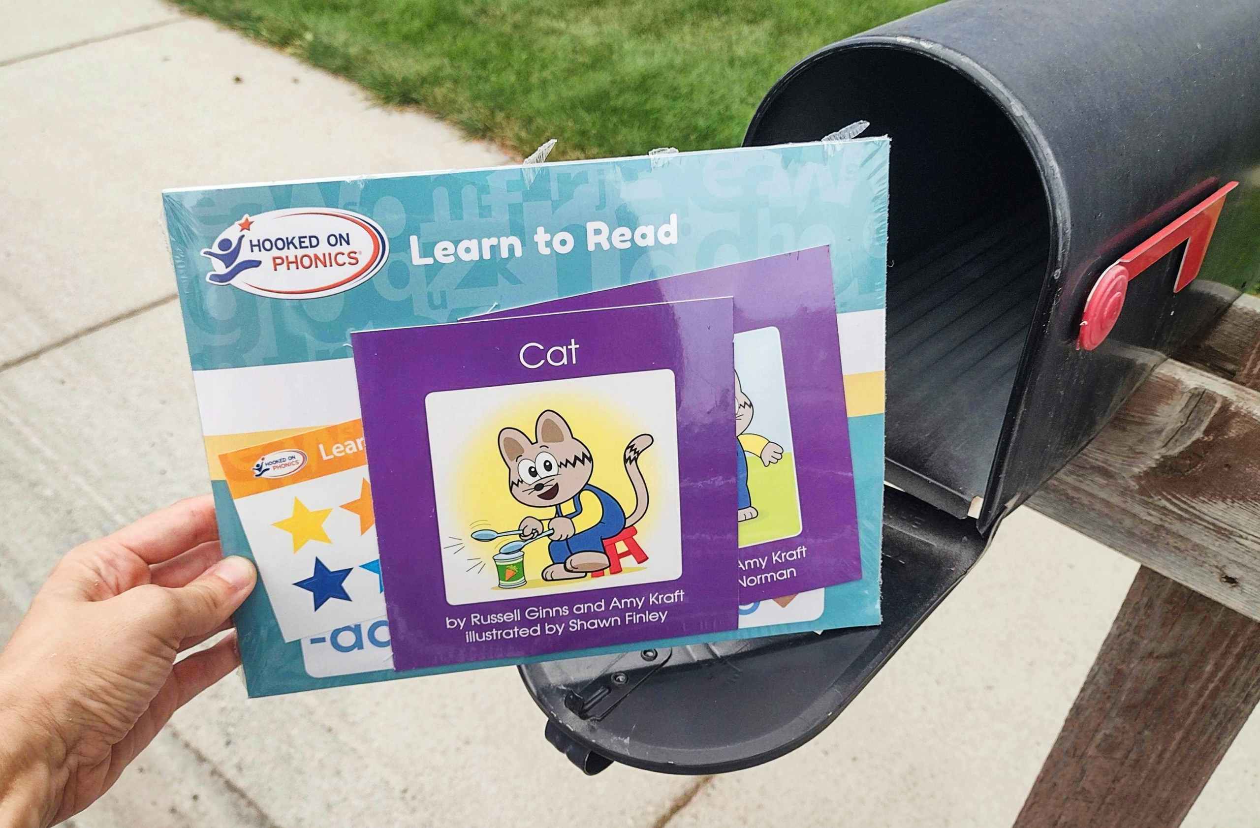 hooked on phonics materials held next to a mailbox