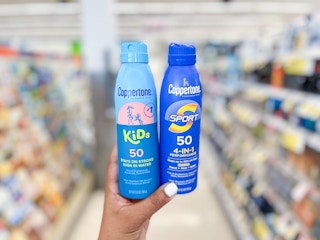 hand holding kids and adults coppertone sunscreen