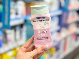 hand holding baby coppertone sunscreen