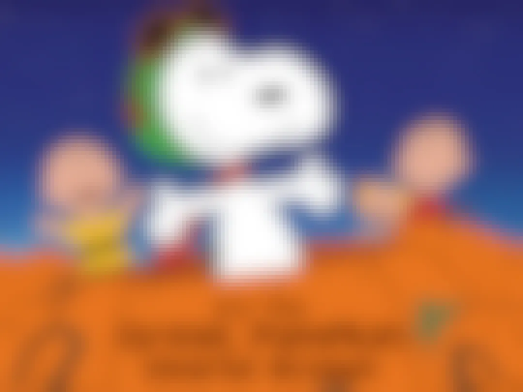 Snoopy popping out of a pumpkin that reads, "It's the Great Pumpkin Charlie Brown" with Peanuts characters in the background.