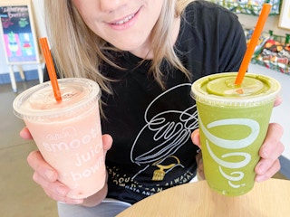 woman holding two jamba juice secret menu smoothies