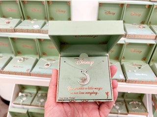 hand holding up Disney Silver plated boxed jewelry