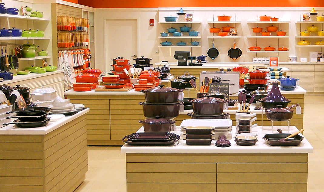 Le Creuset products on shelves in outlet store